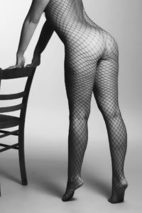 a woman standing beside a chair
